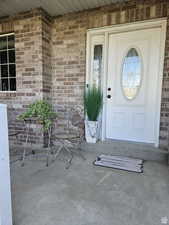 Entrance to property featuring brick siding