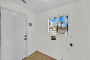 Laundry room featuring washer hookup, visible vents, electric dryer hookup, laundry area, and baseboards