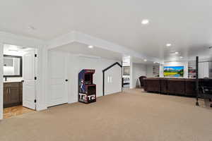 Interior space featuring light carpet, built in features, and recessed lighting