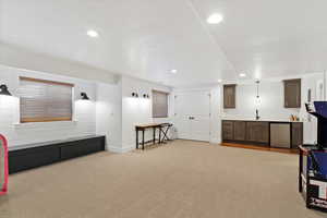 Interior space with recessed lighting, baseboards, a sink, and light colored carpet