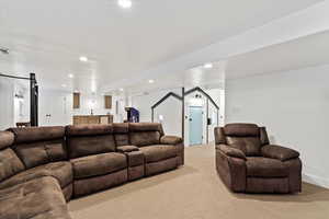 Living area with indoor wet bar, recessed lighting, light colored carpet, and visible vents