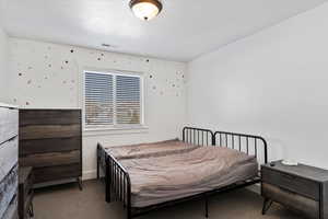 Bedroom featuring carpet floors and visible vents