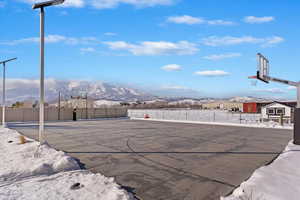 View of private basketball/pickleball court featuring, a mountain view, and fence