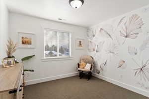 Sitting room with carpet, visible vents, and baseboards