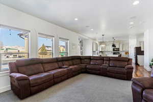 Living room with recessed lighting, a mountain view, and baseboards