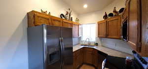 Kitchen featuring stainless steel appliances, light countertops and bright window.