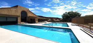 Community pool featuring a patio and fence