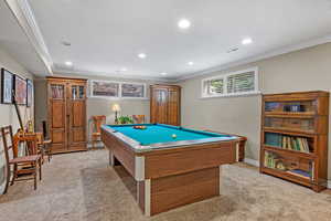 Recreation room with ornamental molding, recessed lighting, visible vents, and light colored carpet