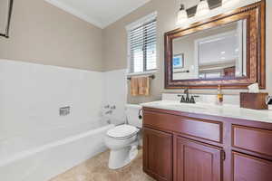 Bathroom featuring toilet, vanity, a bath, tile patterned floors, and crown molding