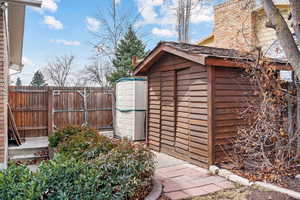 View of shed featuring fence