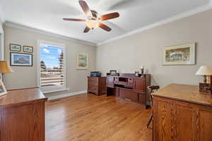 Office featuring light wood-type flooring, crown molding, and baseboards