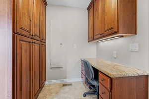 Office area with visible vents, baseboards, and light tile patterned floors