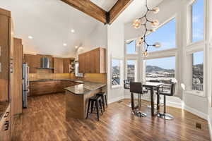 Kitchen featuring a mountain view, a sink, a kitchen breakfast bar, open shelves, and pendant lighting