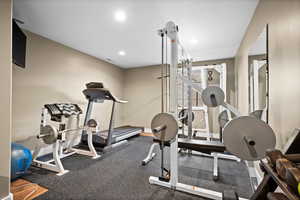 Workout room with recessed lighting and baseboards