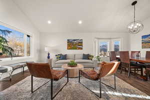 Living area with lofted ceiling, dark wood-type flooring, and recessed lighting