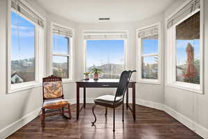 Sunroom featuring visible vents and a mountain view