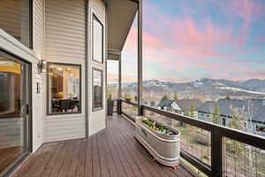 Deck at dusk with a residential view and a mountain view