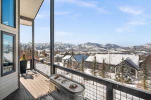 Snow covered deck with a mountain view