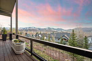 Deck at dusk with a residential view and a mountain view