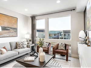 Living area featuring light wood-style flooring, baseboards, and recessed lighting