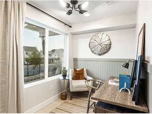 Living area featuring a wainscoted wall and light wood-style flooring