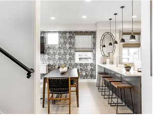 Dining area featuring recessed lighting, baseboards, a healthy amount of sunlight, and light wood finished floors