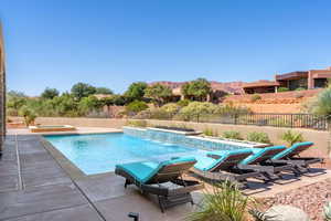 View of pool with a fenced in pool, a patio area, a fenced backyard, and a mountain view