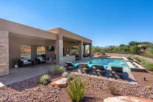 View of swimming pool with outdoor lounge area, a fenced in pool, and a patio