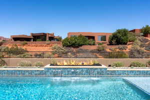 View of pool featuring a fenced in pool and fence