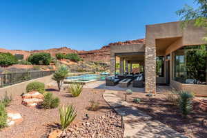 Exterior space with a mountain view, fence, outdoor lounge area, and a fenced in pool