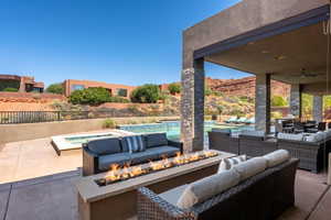 View of patio / terrace featuring ceiling fan, an outdoor living space, fence, and a fenced in pool