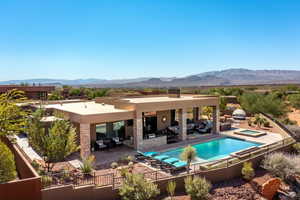 Rear view of house with outdoor lounge area, a patio area, fence, and a mountain view