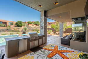 View of patio with a grill, a pool, a fenced backyard, and area for grilling