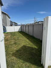 View of yard featuring a residential view and fence