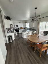Dining room featuring dark wood finished floors and a textured ceiling