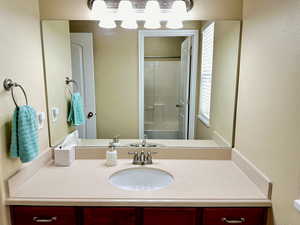 Bathroom featuring a shower and vanity