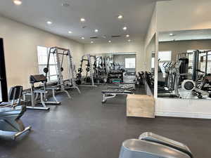 Exercise room with recessed lighting and visible vents