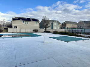 Community pool featuring fence and a residential view