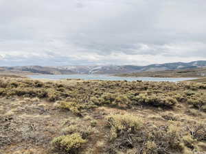 Property view of mountains with a water view