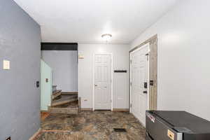 Entryway showing front door, half bath doorway, and stairs to Level 2.