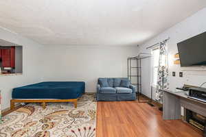 Living area with a textured ceiling (needs patch finished and new paint on the wall.) Floors are laminate.