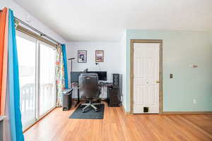 Sliding glass door to back yard, nook used as home office. Doorway to basement.