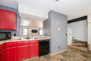 Kitchen featuring open countertop into living room.