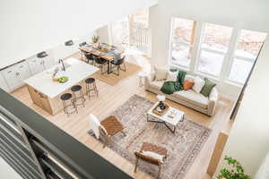 Living room featuring baseboards, visible vents, and light wood-style floors