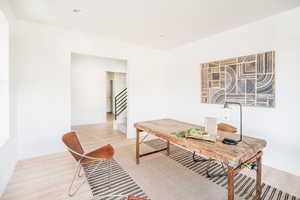 Home office with light wood-type flooring, baseboards, and recessed lighting