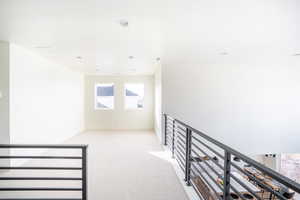 Hall featuring recessed lighting, light carpet, and baseboards