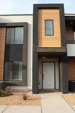 Doorway to property featuring central air condition unit and stucco siding