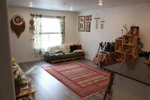 Living area with wood finished floors and baseboards