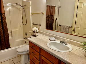 Full bathroom with shower / tub combo, tile patterned flooring, vanity, and toilet