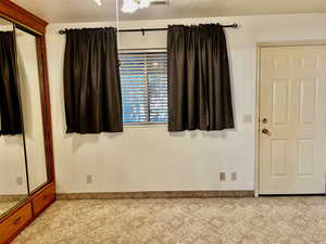 Unfurnished room featuring light carpet and visible vents